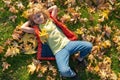 Kids play in autumn park. Children portrait with yellow leaves. Child boy with oak and maple leaf outdoor. Fall foliage Royalty Free Stock Photo