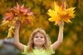 Kids play in autumn park. Children throwing yellow leaves. Child boy with oak and maple leaf outdoor. Fall foliage Royalty Free Stock Photo