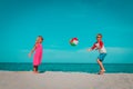 Kids play with ball on beach, boy and girl have fun at sea Royalty Free Stock Photo