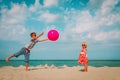 Kids play with ball on beach, boy and girl have fun at sea Royalty Free Stock Photo