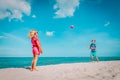 Kids play with ball on beach, boy and girl have fun at sea Royalty Free Stock Photo