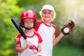 Kids play baseball. Child with bat and ball