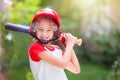 Kids play baseball. Child with bat and ball