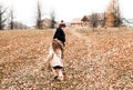 Kids play catch-up in the autumn forest