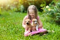 Kids play with puppy. Children and dog in garden.