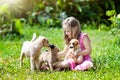 Kids play with puppy. Children and dog in garden.