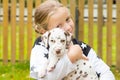 Kids play with cute little puppy. Children and baby dogs playing in sunny summer garden. Little girl holding puppies Royalty Free Stock Photo