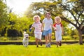 Kids play with dog. Children and puppy run in park Royalty Free Stock Photo