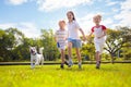 Kids play with dog. Children and puppy run in park Royalty Free Stock Photo