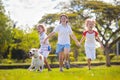 Kids play with dog. Children and puppy run in park Royalty Free Stock Photo