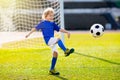 Kids play football. Child at soccer field