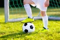 Kids play football. Child at soccer field.