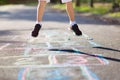 Kids play hopscotch in summer park. Outdoor game Royalty Free Stock Photo