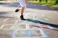 Kids play hopscotch in summer park. Outdoor game Royalty Free Stock Photo