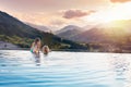 Family in swimming pool with mountain view Royalty Free Stock Photo