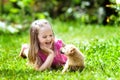 Kids play with puppy. Children and dog in garden