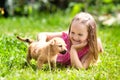 Kids play with puppy. Children and dog in garden Royalty Free Stock Photo