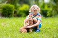 Kids play with puppy. Children and dog in garden Royalty Free Stock Photo