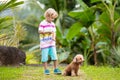 Kids play with puppy. Children and dog in garden Royalty Free Stock Photo