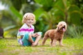 Kids play with puppy. Children and dog in garden Royalty Free Stock Photo