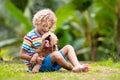 Kids play with puppy. Children and dog in garden Royalty Free Stock Photo