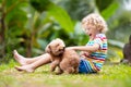 Kids play with puppy. Children and dog in garden Royalty Free Stock Photo