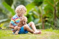 Kids play with puppy. Children and dog in garden Royalty Free Stock Photo