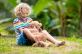 Kids play with puppy. Children and dog in garden Royalty Free Stock Photo