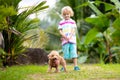 Kids play with puppy. Children and dog in garden Royalty Free Stock Photo