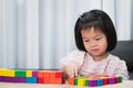 Kids play room. Child sweet smile playing building wooden colorful blocks toys. Development and Construction from the imagination Royalty Free Stock Photo