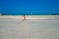 Kids play and run on the famous sandy beach of Elafonissi, Crete, Greece.