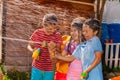 Kids play shooting water gun game, hot summer day Royalty Free Stock Photo