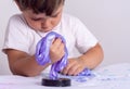 Kids play with slime. Boy stretch handgum or toy slime.