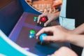Kids play slot machine at amusement theme park, children play arcade gaming machine, racing and shooting game at the fair, Royalty Free Stock Photo