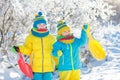 Kids play in snow. Winter sled ride for children Royalty Free Stock Photo