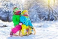 Kids play in snow. Winter sled ride for children Royalty Free Stock Photo