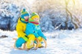 Kids play in snow. Winter sled ride for children Royalty Free Stock Photo