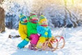Kids play in snow. Winter sled ride for children Royalty Free Stock Photo