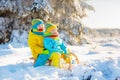 Kids play in snow. Winter sled ride for children Royalty Free Stock Photo