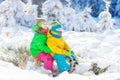 Kids play in snow. Winter sled ride for children Royalty Free Stock Photo