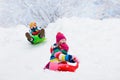 Kids play in snow. Winter sled ride for children Royalty Free Stock Photo