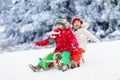 Kids play in snow. Winter sleigh ride for children