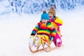 Kids play in snow. Winter sleigh ride for children Royalty Free Stock Photo