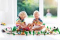 Children play wiht toy train. Kids wooden railway. Royalty Free Stock Photo