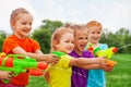 Kids play with water guns on a meadow Royalty Free Stock Photo