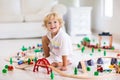 Kids play wooden railway. Child with toy train