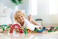 Kids play wooden railway. Child with toy train Royalty Free Stock Photo