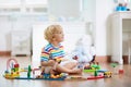 Kids play wooden railway. Child with toy train Royalty Free Stock Photo