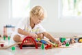 Kids play wooden railway. Child with toy train Royalty Free Stock Photo