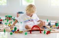 Kids play wooden railway. Child with toy train Royalty Free Stock Photo